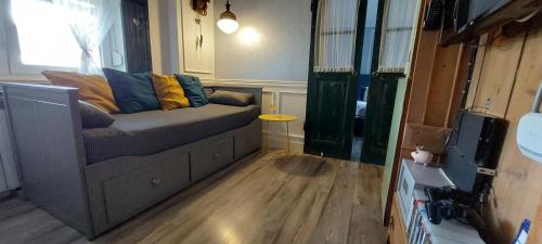a living room with a couch with pillows on it at Apartment Sabljaci by the Lake in Ogulin