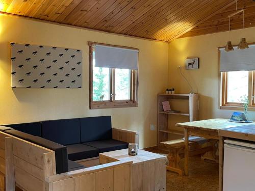 a living room with a couch and a table at Dalsvallen in Sveg