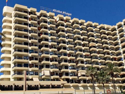 a large apartment building with balconies on the beach at Benalmadena ALOHA PLAYA SEA VIEW LOFT in Benalmádena