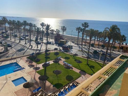 an aerial view of a park with palm trees and the ocean at Benalmadena ALOHA PLAYA SEA VIEW LOFT in Benalmádena
