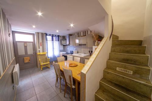 a kitchen and dining room with a wooden table and stairs at Venez Rêver Béziers CENTRE et GARE il y a plus cher mais c est moins bien in Béziers