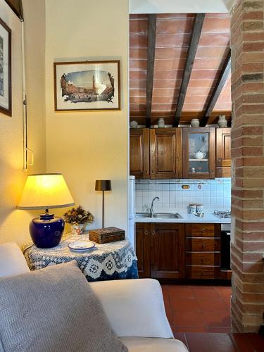 a kitchen with a table with a lamp on it at Monteriggioni Castello in Monteriggioni