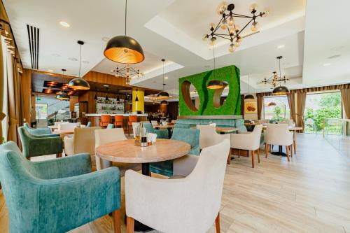 a dining room with tables and chairs and a restaurant at Radsor Hotel in Râşnov