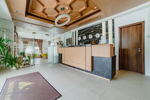 an office lobby with a kitchen and a wooden door at Radsor Hotel in Râşnov