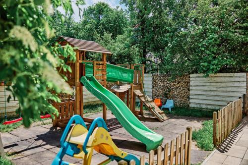 a playground with a slide and a gazebo at Radsor Hotel in Râşnov