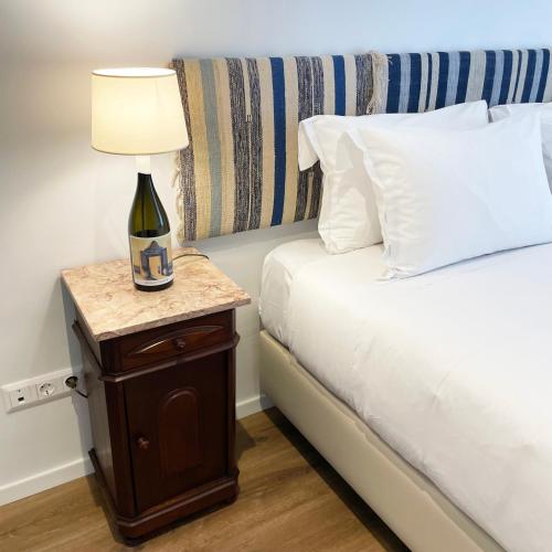 a bedroom with a bed with a lamp on a night stand at Villa Alter in Alter do Chão