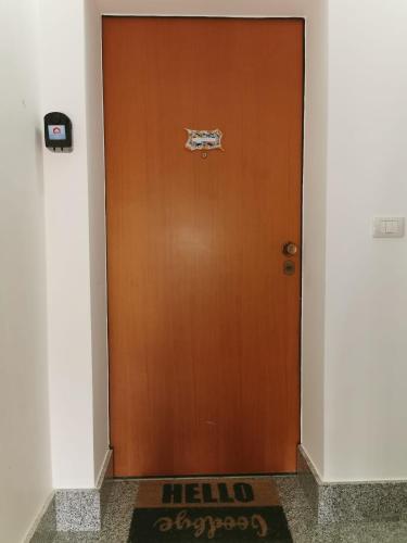 a brown door in a hallway with a sign on it at Scala dei Turchi Apartment in Realmonte