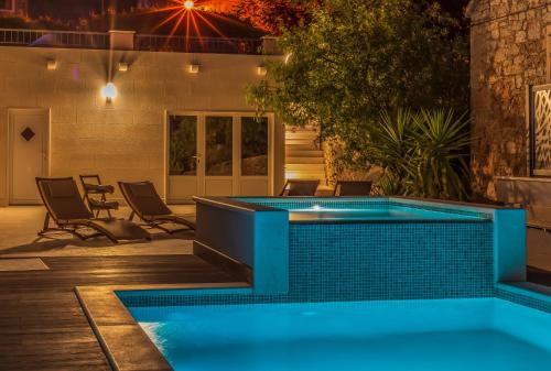 a swimming pool in the middle of a yard at night at Bol Summer Residence in Bol