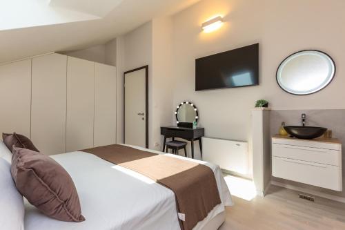 a bedroom with a bed and a sink and a mirror at Bol Summer Residence in Bol