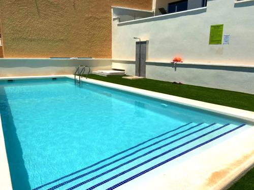 a large swimming pool in the middle of a house at Villa Isla Plana, right by the sea - Grande in Isla Plana