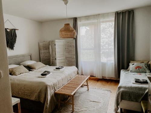 a bedroom with two beds and a bench in it at Simply rooms in Slavkov u Brna