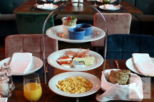 a table with three plates of food on it at ARGENTA Living 16 in Künzell