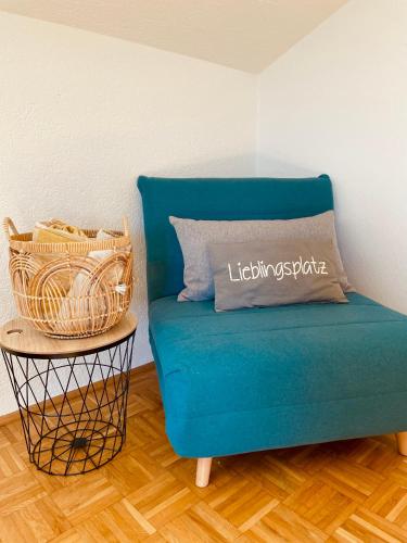 a blue couch in a room with a side table at KAINZLEITENHOF in Nachdemsee