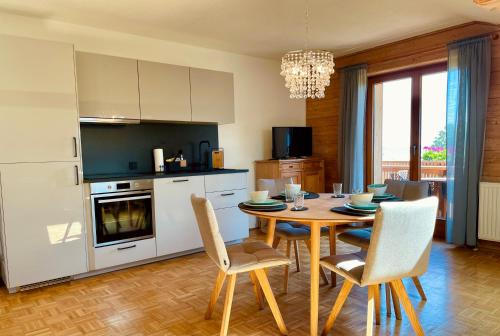 a kitchen with a table and chairs in a kitchen at KAINZLEITENHOF in Nachdemsee