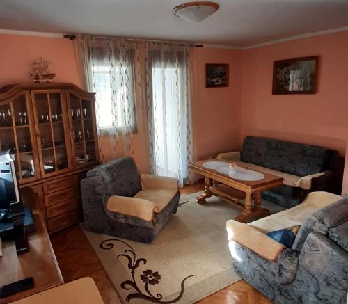 a living room with two couches and a table at Apartman Sofija in Plužine