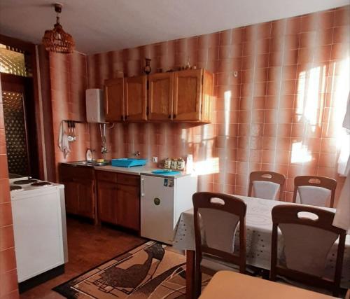 a kitchen with a table and chairs in a room at Apartman Sofija in Plužine