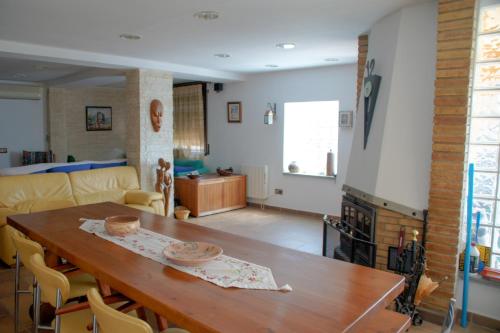 a living room with a wooden table and a couch at Casa Martina in Cardedeu