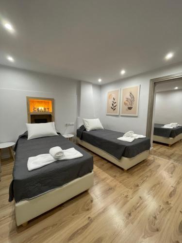 a bedroom with two beds and a fireplace at Aqua Vero Seaside Residence in Hersonissos