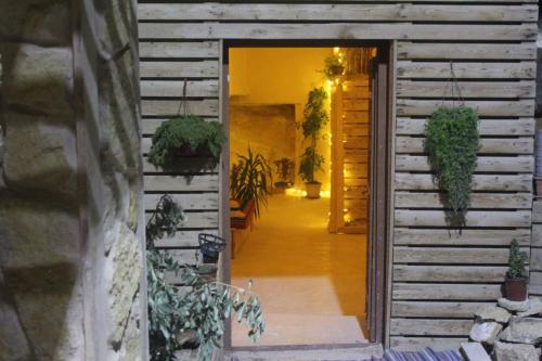 a hallway of a house with potted plants at 7 Caves Hotel in Al Jāyah
