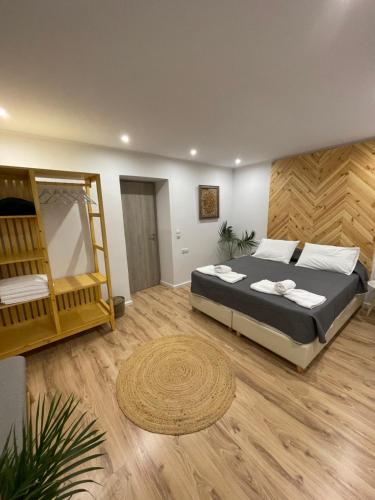 a bedroom with a bed and a wooden floor at AQUA VERO sea residence in Hersonissos