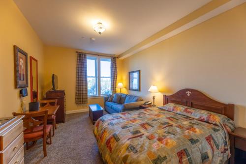 a bedroom with a bed and a desk and a chair at Seneca Unit 102 in Snowshoe