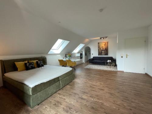 a bedroom with a bed and a living room at Ferienwohnungen Salz und mehr in Bad Sassendorf
