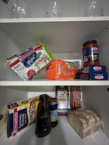 a refrigerator filled with food and other food items at Aqua Vero Seaside Residence in Hersonissos