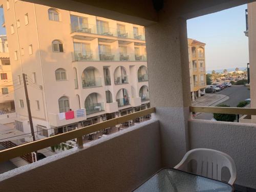 a balcony with a table and a view of a building at Green Nondas Hill A in Larnaka