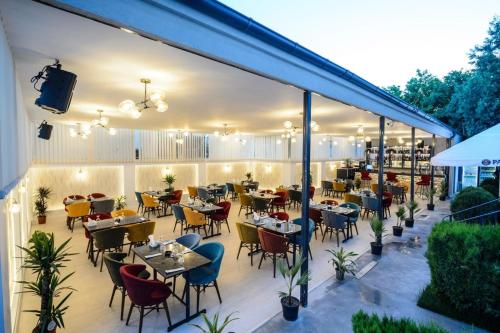 a restaurant with tables and chairs on a patio at Casa ON in Mamaia Sat/Năvodari