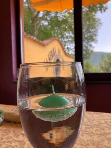 a wine glass with a candle in it on a table at Agriturismo La Gemma del Parco in Mormanno