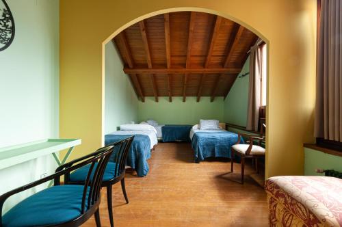 a room with four beds with blue sheets at Vivienda Vacacional Leo in Andrín
