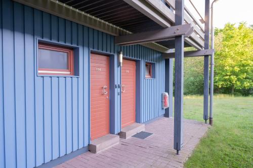 a blue building with two red doors on it at Sportcampus Saar in Saarbrücken