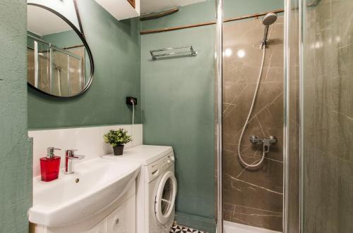 a bathroom with a sink and a shower at Pomorska Rooms in Łódź