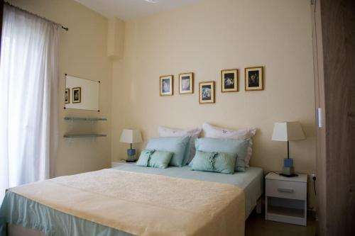 A bed or beds in a room at Blue Theros Apartments