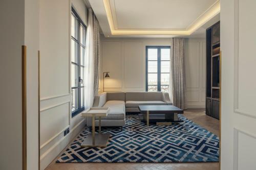 a living room with a couch and a table at Mansard Riyadh, a Radisson Collection Hotel in Riyadh