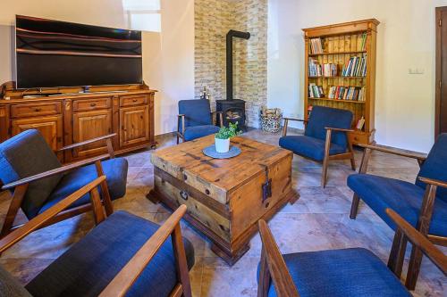 a living room with a table and chairs and a tv at Chalupa Křenov 62 in Bernartice