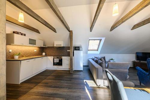 a kitchen and living room with a couch and a table at Chalupa Křenov 62 in Bernartice