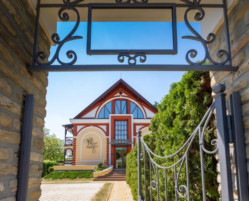 an entrance to a house with a gate at Hotel Vila Lago in Palić