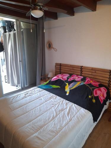 un grand lit dans une chambre avec une fenêtre dans l'établissement DUPLEX CAP D AGDE PISCINE, au Cap d'Agde