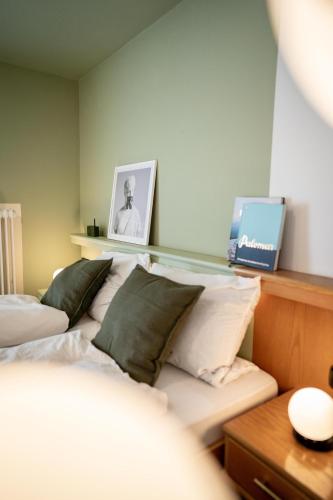 a bedroom with two beds and a table with a laptop at DAS SCHÖNE LEBEN Pop-Up Hotel in Hornberg