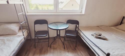a room with three chairs and a table and a bed at Noclegi u Eli Zator Energylandia in Zator