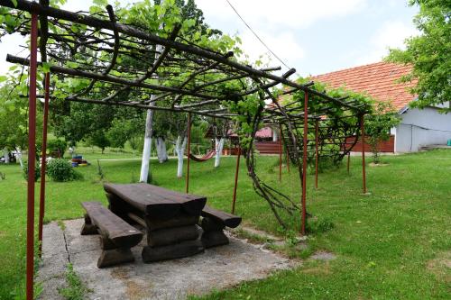a picnic table and a bench in a yard at House Luna in Rakovica
