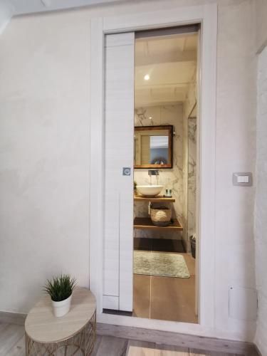 a bathroom with a sink and a mirror at Torino Vacancy San Tommaso Suite in Turin
