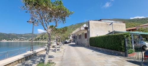 a sidewalk next to a building next to the water at Mar Do Sol in Agnone