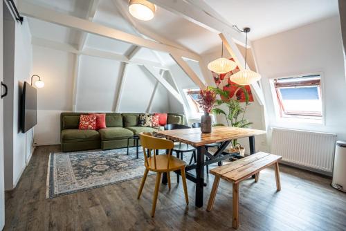 a living room with a table and a couch at Casa Coral - a hidden gem for families in Groningen