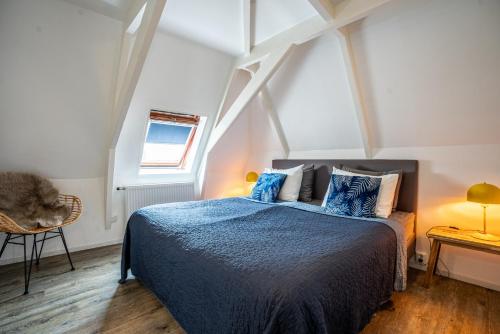 a bedroom with a bed with a cat sitting on it at Casa Coral - a hidden gem for families in Groningen