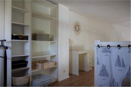 a room with a closet with shelves and a curtain at Petite maison dans résidence avec piscine proche plage et centre ville à pied in Pornic