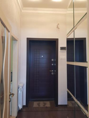 a black door in a hallway with a glass doorway at Central Baku Luxury Apartment on Nizami Street in Baku