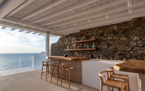 a bar with a view of the ocean at Villa Santa Esmeralda Mykonos in Agios Ioannis Mykonos