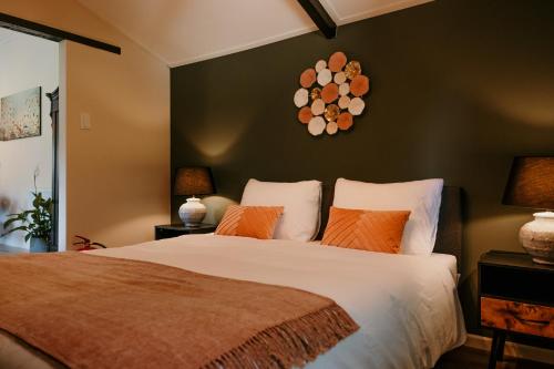 a bedroom with a large bed with orange pillows at In de tuin in Gees in Gees
